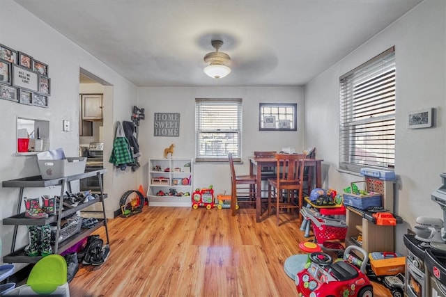 rec room featuring ceiling fan and light wood-type flooring