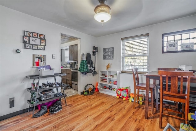 rec room with light hardwood / wood-style flooring