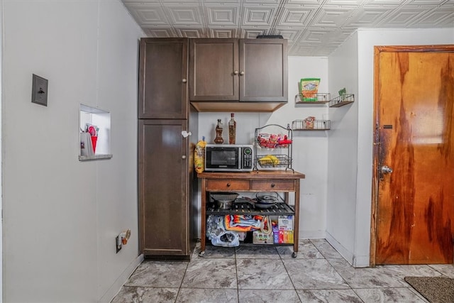 kitchen featuring dark brown cabinetry