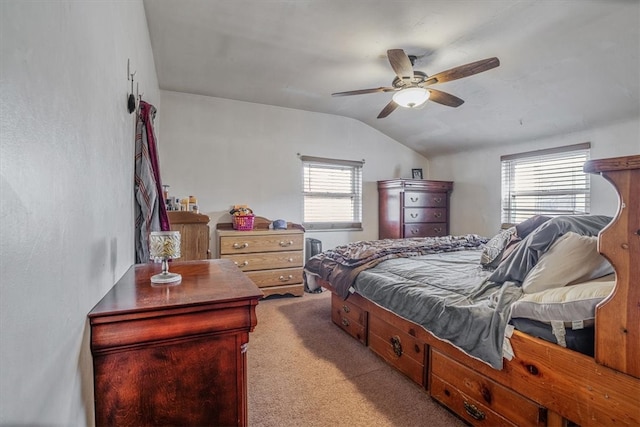 carpeted bedroom featuring ceiling fan and vaulted ceiling