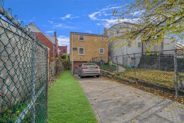 view of parking featuring a yard