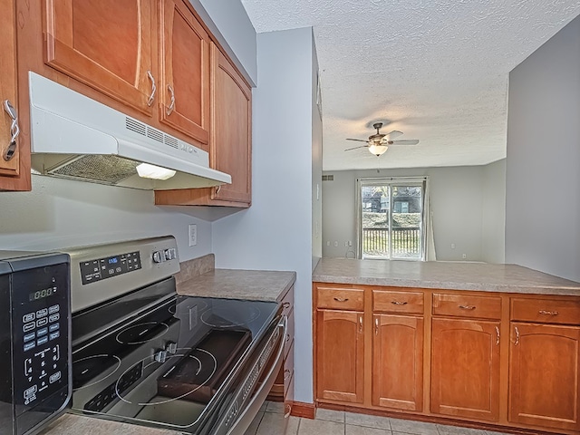 kitchen with kitchen peninsula, a textured ceiling, ceiling fan, light tile patterned flooring, and stainless steel electric range oven