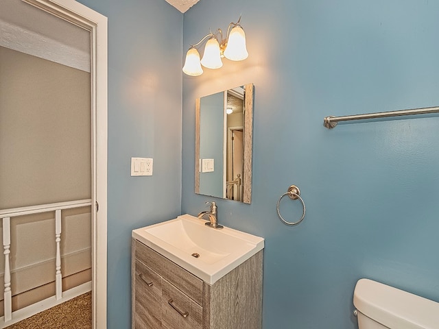 bathroom featuring toilet and vanity