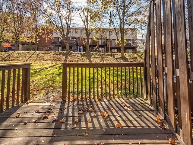 wooden terrace featuring a yard