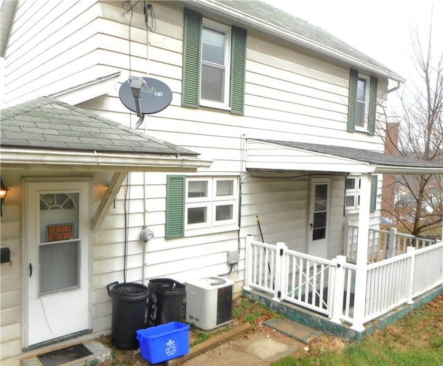 rear view of house featuring central air condition unit