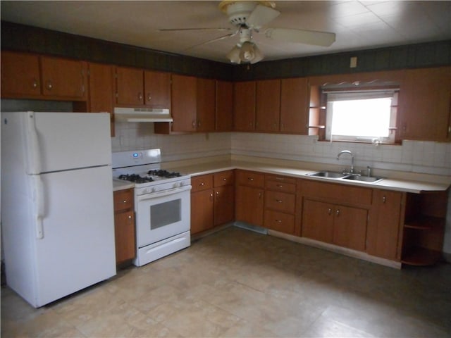 kitchen with tasteful backsplash, white appliances, sink, and ceiling fan