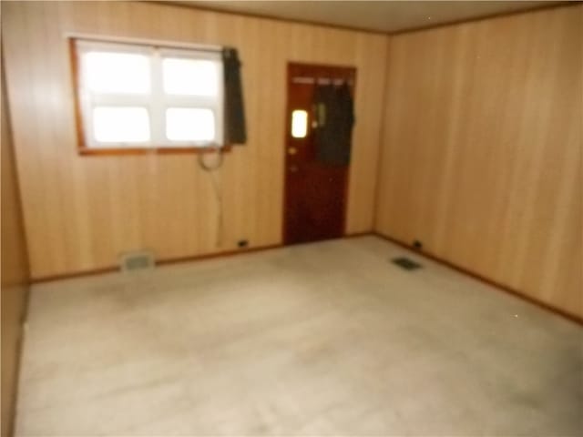 unfurnished room featuring light carpet