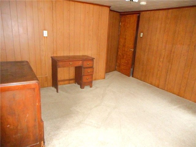 office area with wood walls and light colored carpet