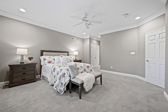 carpeted bedroom with ornamental molding, a closet, and ceiling fan