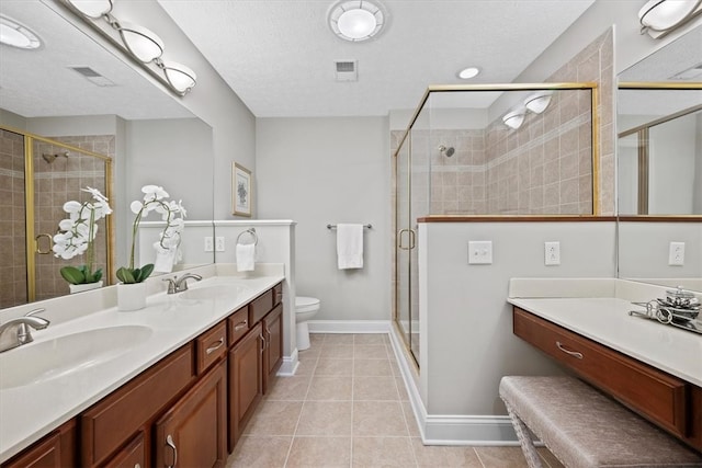 bathroom with walk in shower, vanity, a textured ceiling, and tile patterned flooring