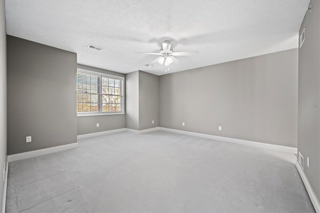 carpeted empty room with a textured ceiling and ceiling fan