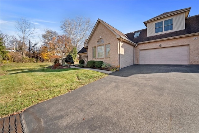 view of front of house with a garage and a front lawn