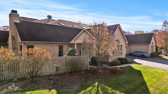 view of side of property with a lawn