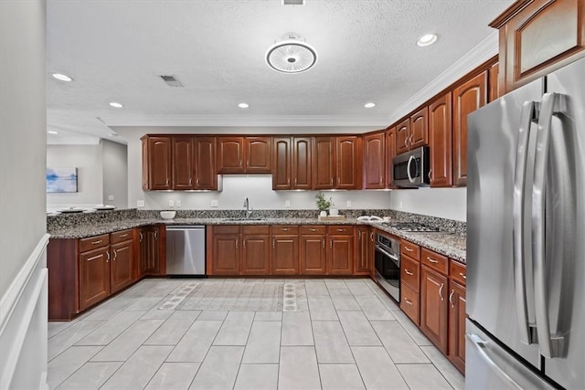 kitchen featuring stainless steel appliances, a textured ceiling, light tile patterned floors, sink, and dark stone countertops