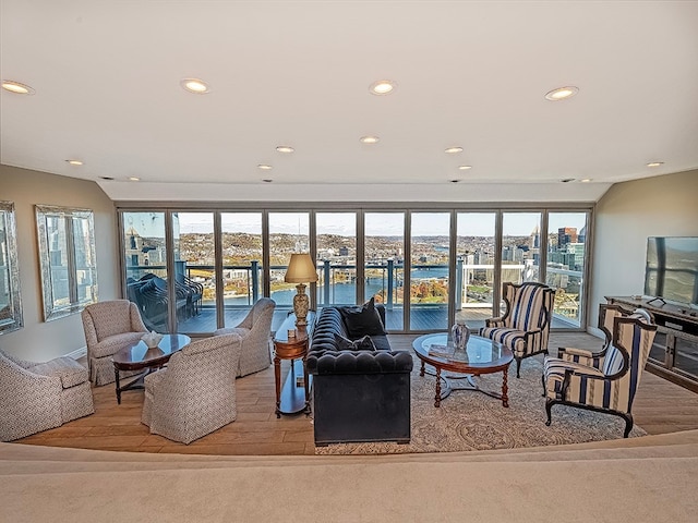 living room featuring a wealth of natural light and light hardwood / wood-style flooring