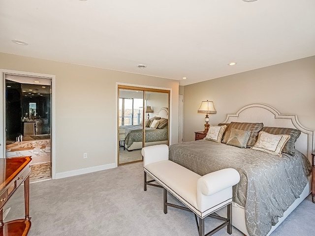 bedroom featuring a closet and light carpet