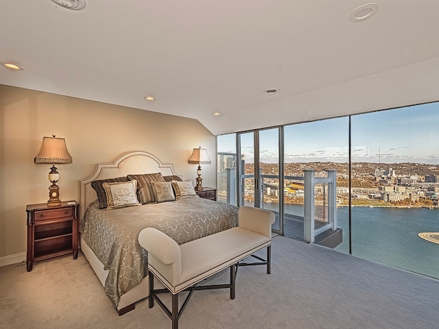 bedroom featuring access to outside, lofted ceiling, and light carpet