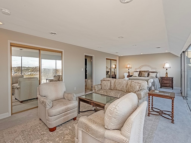 bedroom with vaulted ceiling and light colored carpet