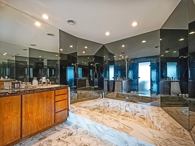 bathroom with vanity and a tub to relax in