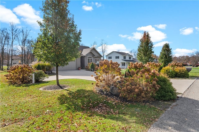 view of front of home with a front yard and a garage