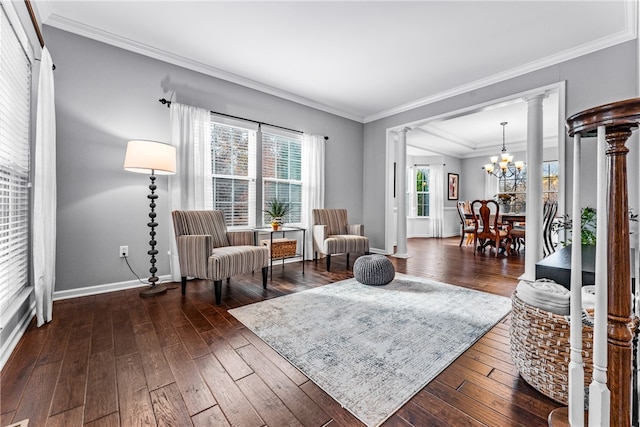 sitting room with dark hardwood / wood-style floors, ornate columns, and ornamental molding