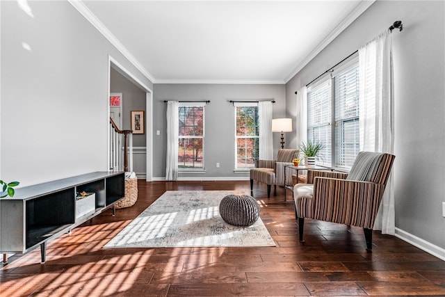 sitting room featuring ornamental molding and dark hardwood / wood-style flooring