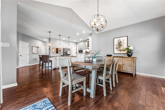 dining space featuring lofted ceiling, an inviting chandelier, and dark hardwood / wood-style floors