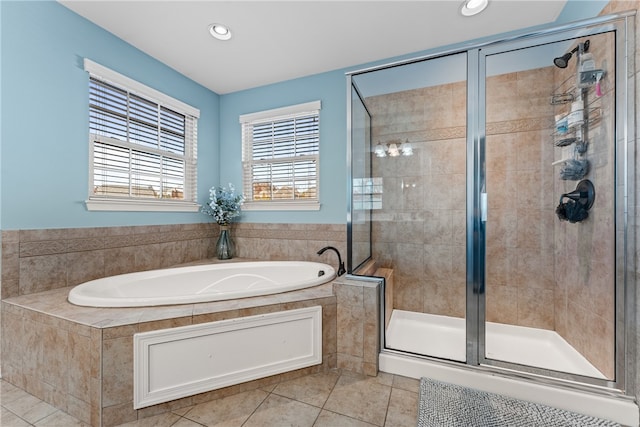 bathroom with independent shower and bath and tile patterned flooring