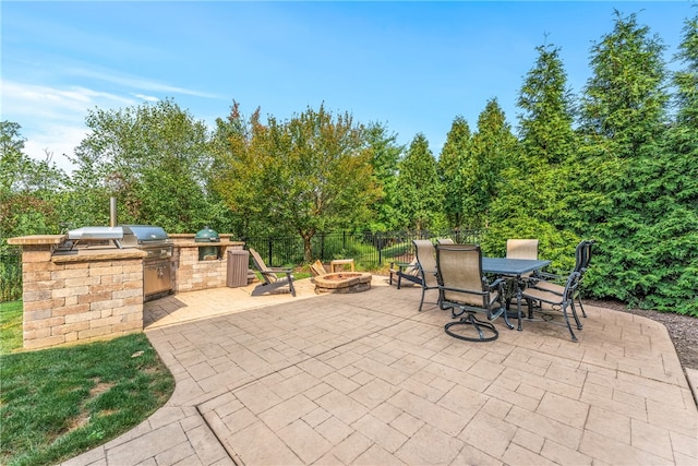 view of patio featuring a grill, a fire pit, and area for grilling