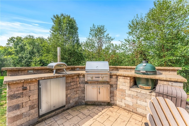 view of patio / terrace with an outdoor kitchen and a grill