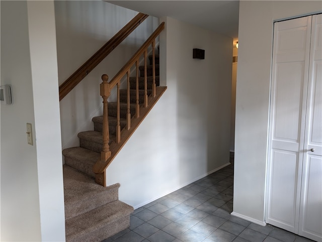 staircase with tile patterned flooring