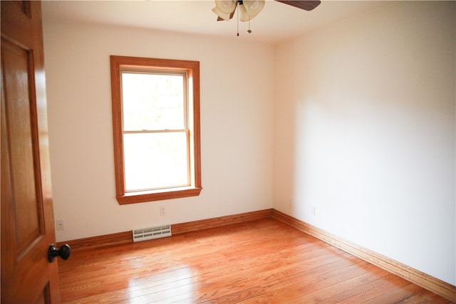 spare room with light wood-type flooring and ceiling fan