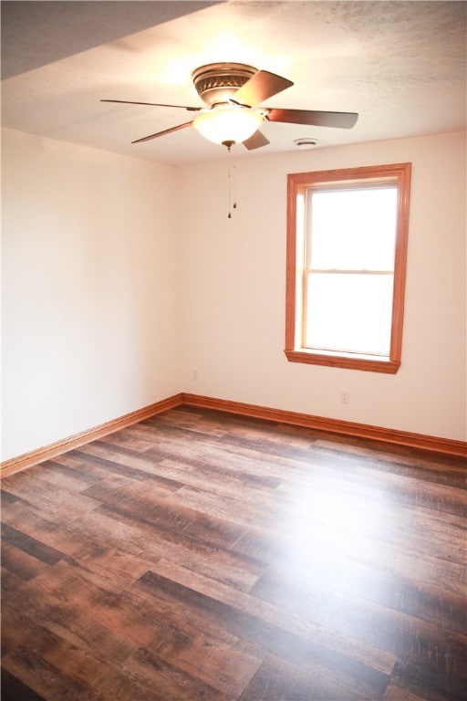 spare room with ceiling fan and dark hardwood / wood-style floors