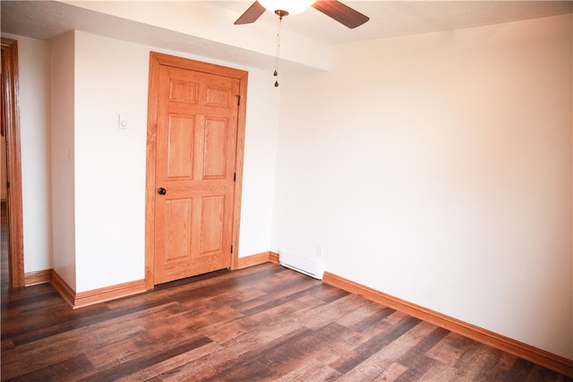 empty room with ceiling fan and dark hardwood / wood-style floors