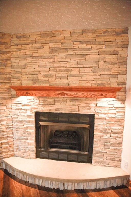 details with a fireplace and hardwood / wood-style flooring