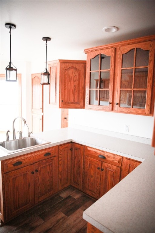 kitchen with dark wood-type flooring, sink, and decorative light fixtures