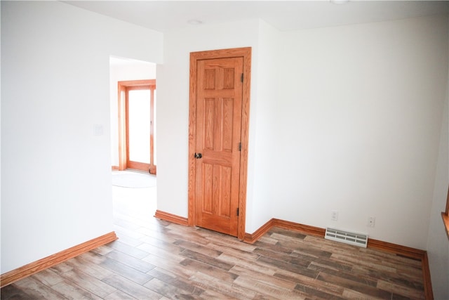 spare room featuring wood-type flooring