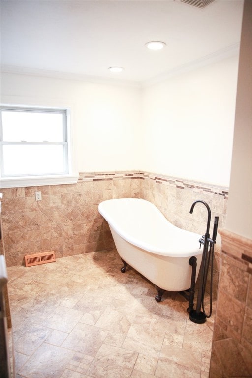 bathroom with tile walls and a bathtub