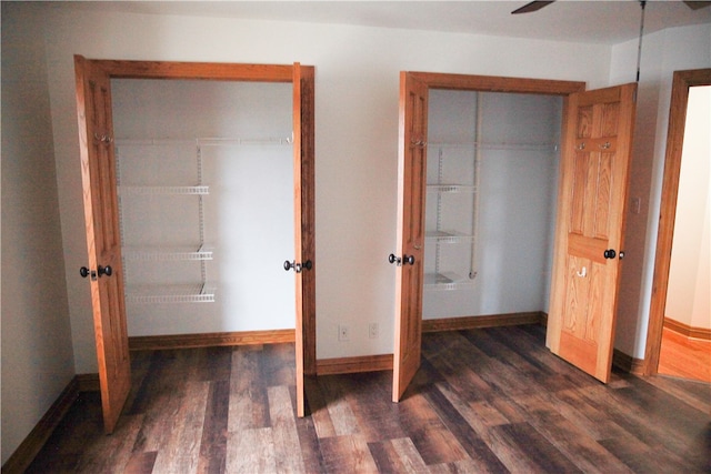 unfurnished bedroom featuring ceiling fan and dark hardwood / wood-style flooring