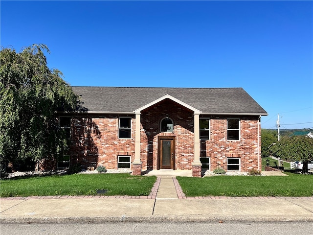 raised ranch with a front yard