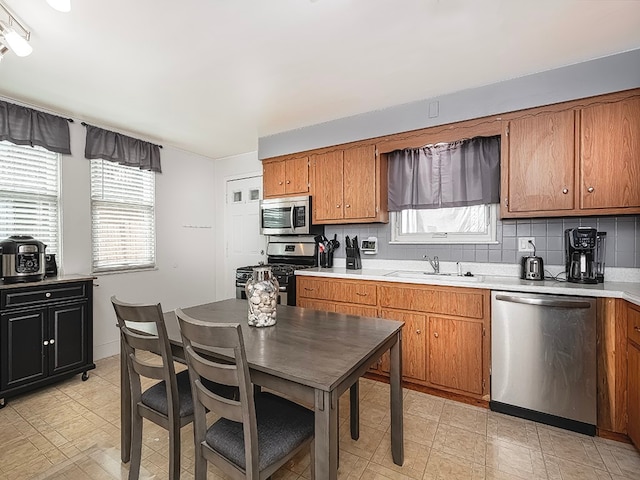 kitchen featuring sink, appliances with stainless steel finishes, and tasteful backsplash