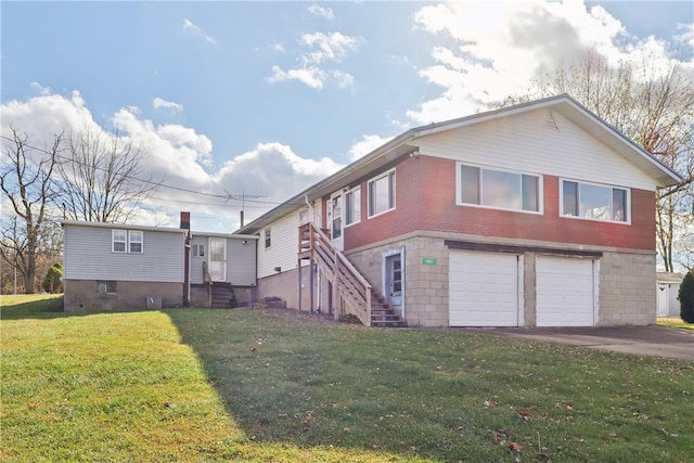 view of front of house with a garage and a front lawn