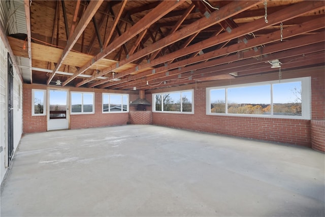 interior space with concrete flooring and brick wall