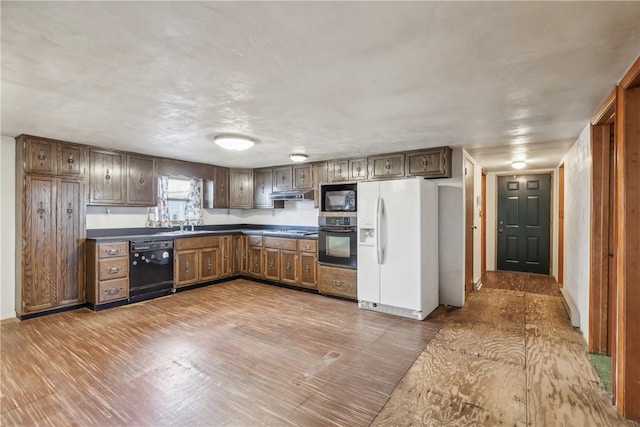 kitchen featuring black appliances and wood-type flooring