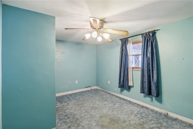 empty room featuring ceiling fan and carpet