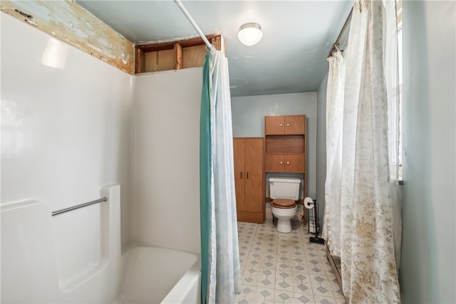 bathroom featuring shower / bath combo with shower curtain and toilet