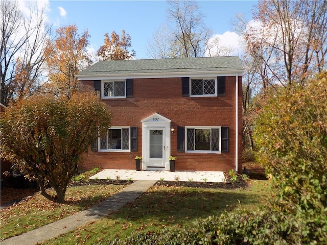 view of front facade with a patio area and a front lawn