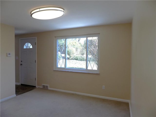 view of carpeted entrance foyer