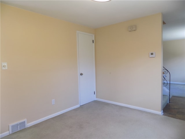 unfurnished room with light carpet