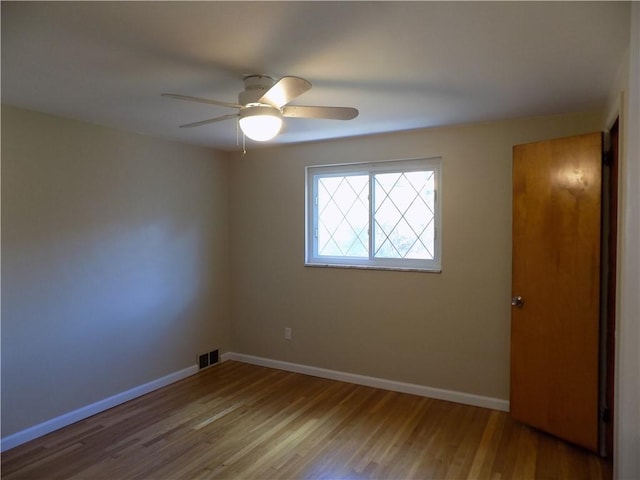 empty room featuring wood-type flooring and ceiling fan